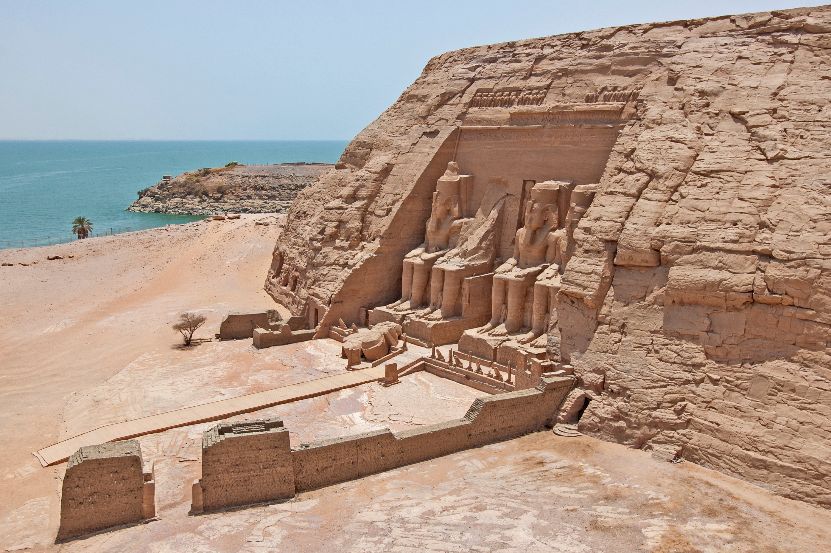 Die monumentalen Statuen der Abu Simbel Tempel, die in den Felsen gehauen sind, mit Blick auf das Wasser.