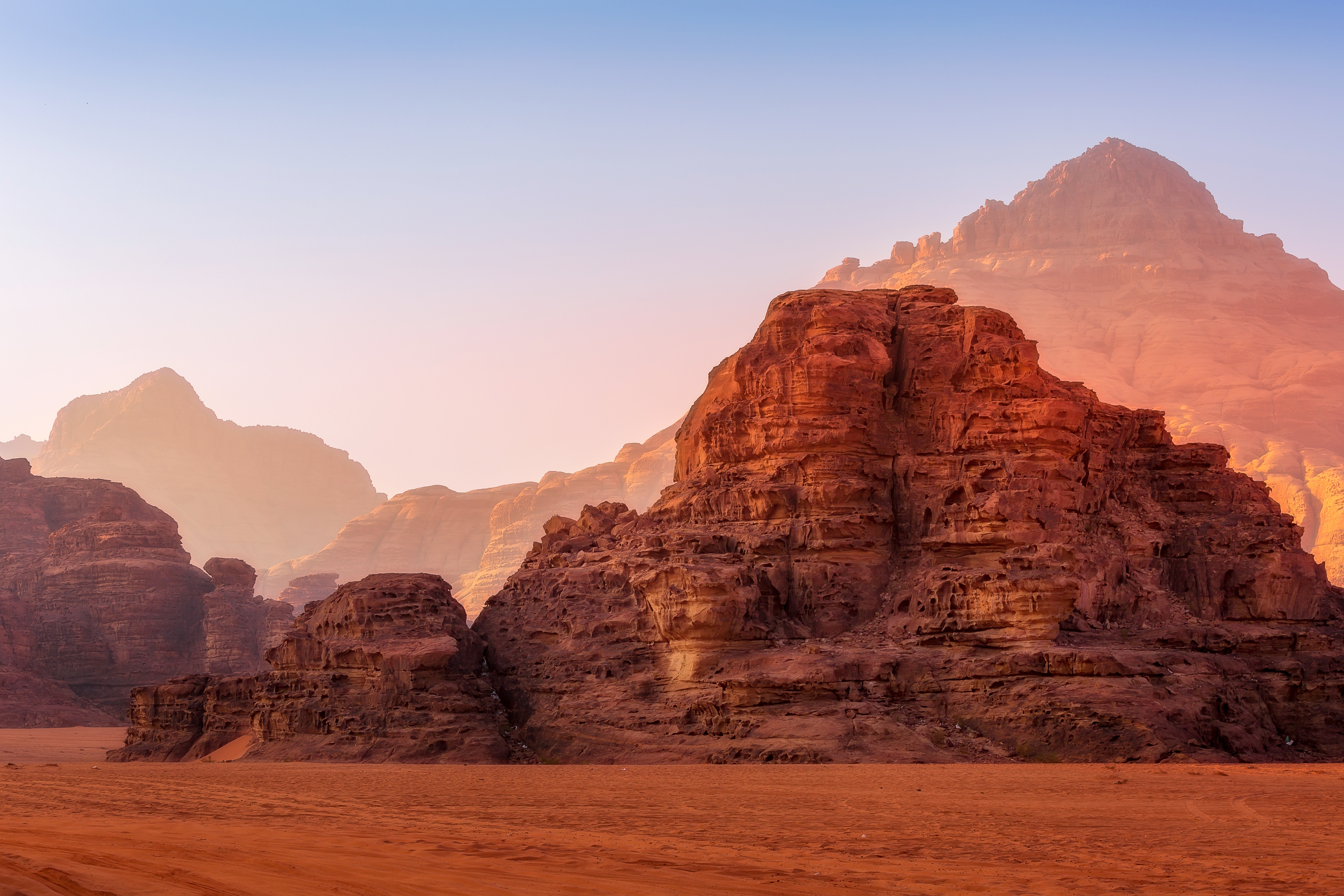 Felsformationen in der Wüste Wadi Rum mit sanften Farben im Morgenlicht.